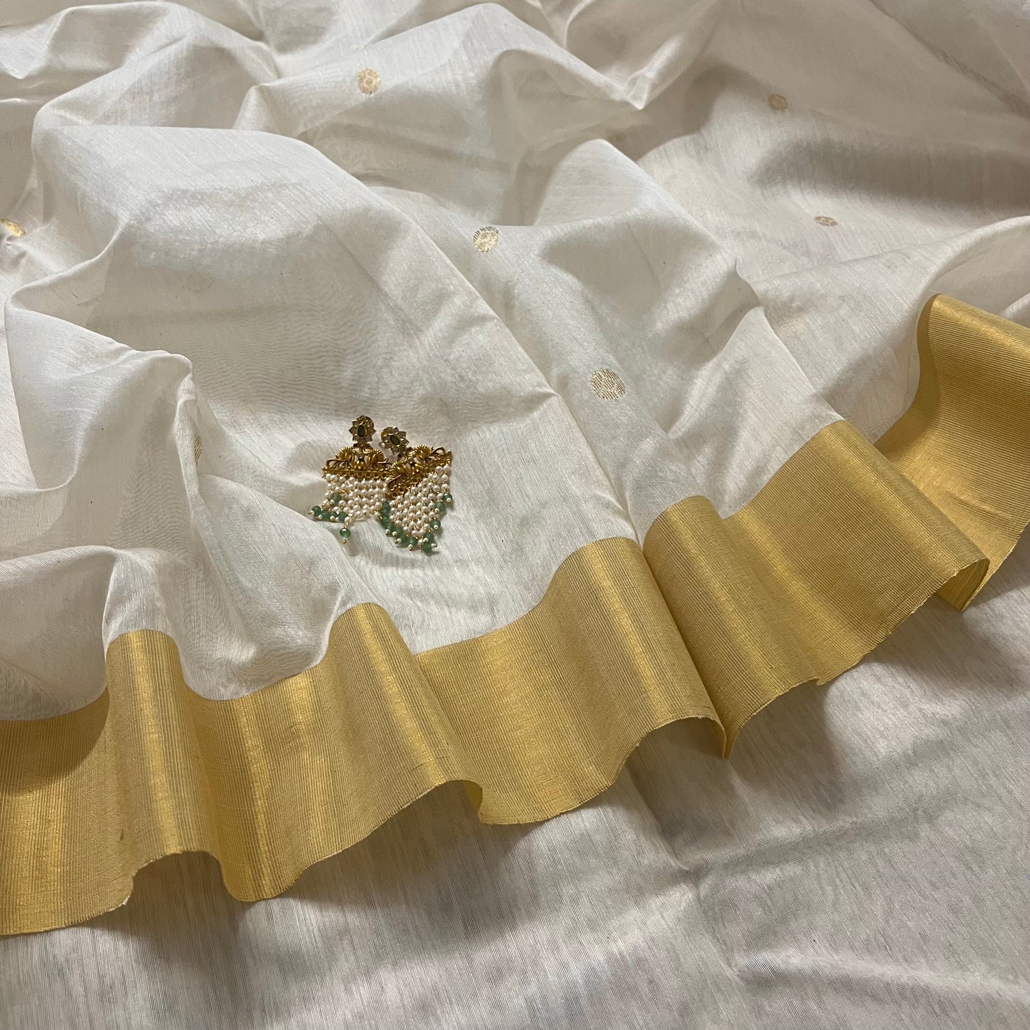 Off white Chanderi saree with zari bootis all over and zari motifs on pallu