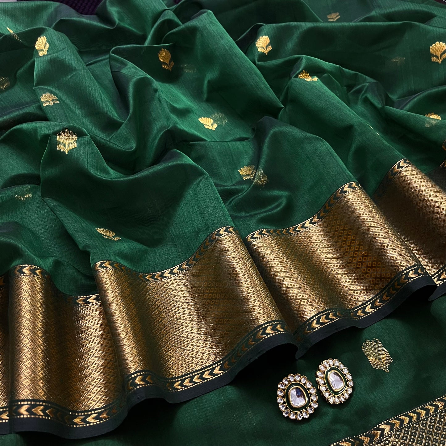 Dark green Maheshwari saree with flower motifs all over