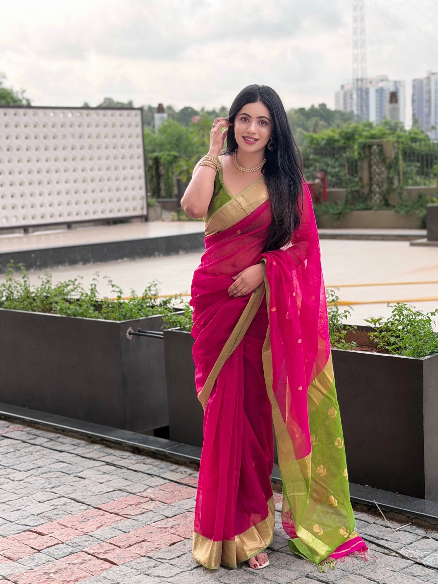 Pink and olive green Maheshwari saree with flower motifs on pallu
