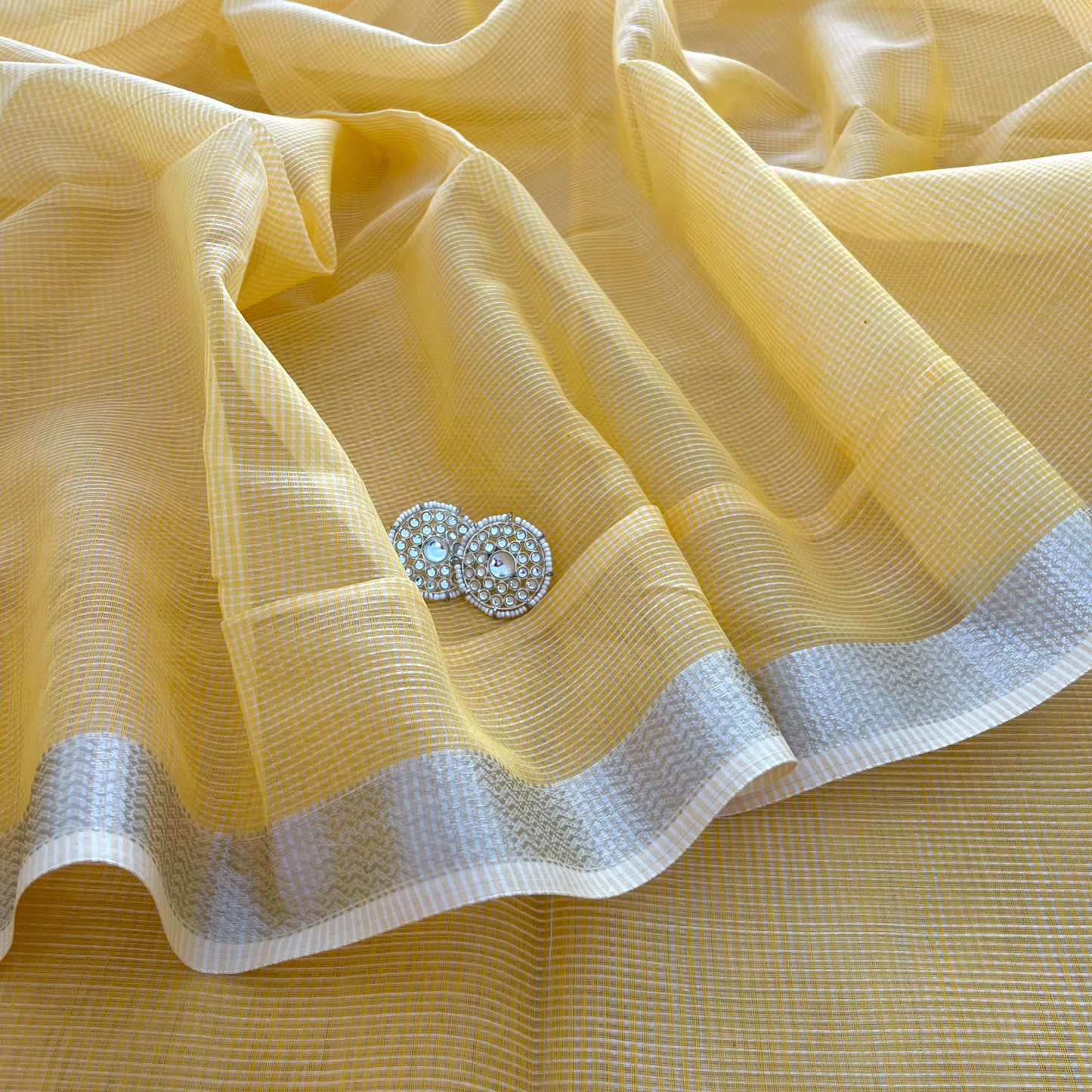 Yellow Maheshwari saree with silver zari border