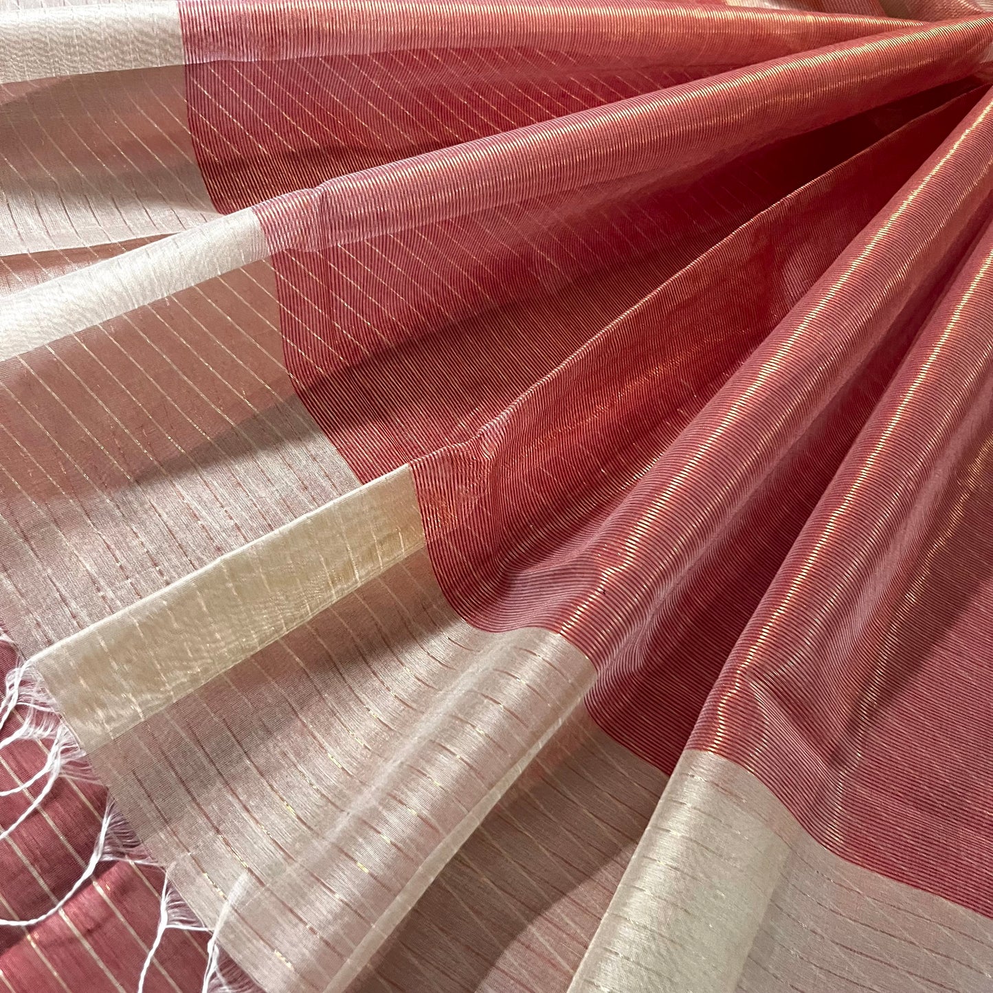 Light beige and red Maheshwari saree with zari lines all over