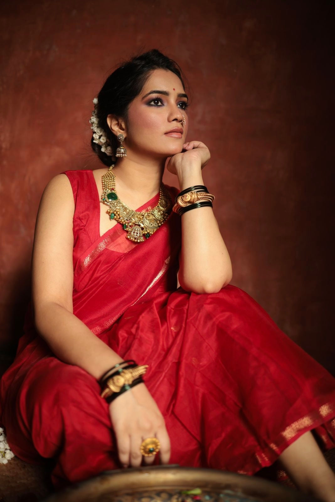 Red maheshwari saree with zari border & zari bootis all over