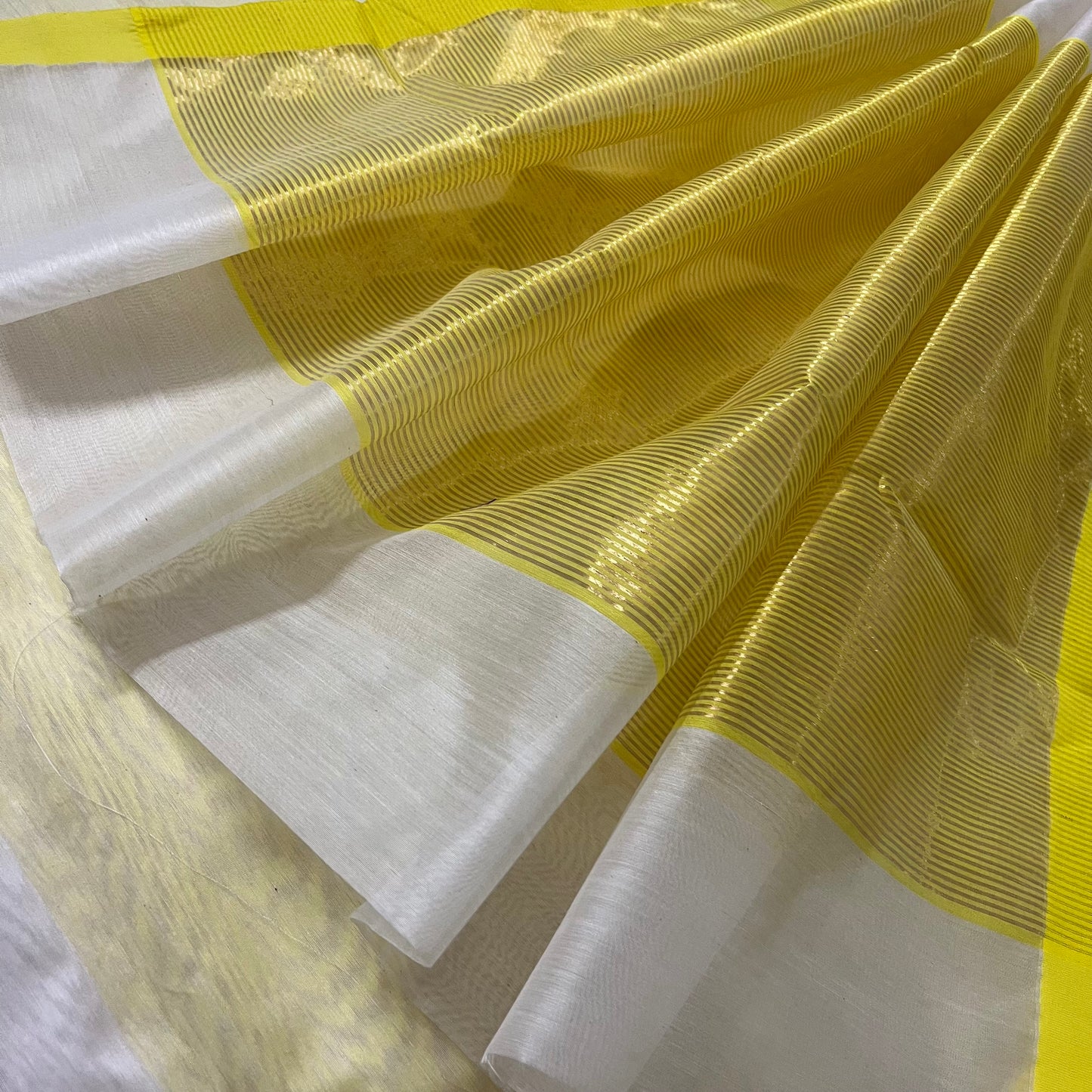 White and lemon Chanderi saree with zari lines on pallu