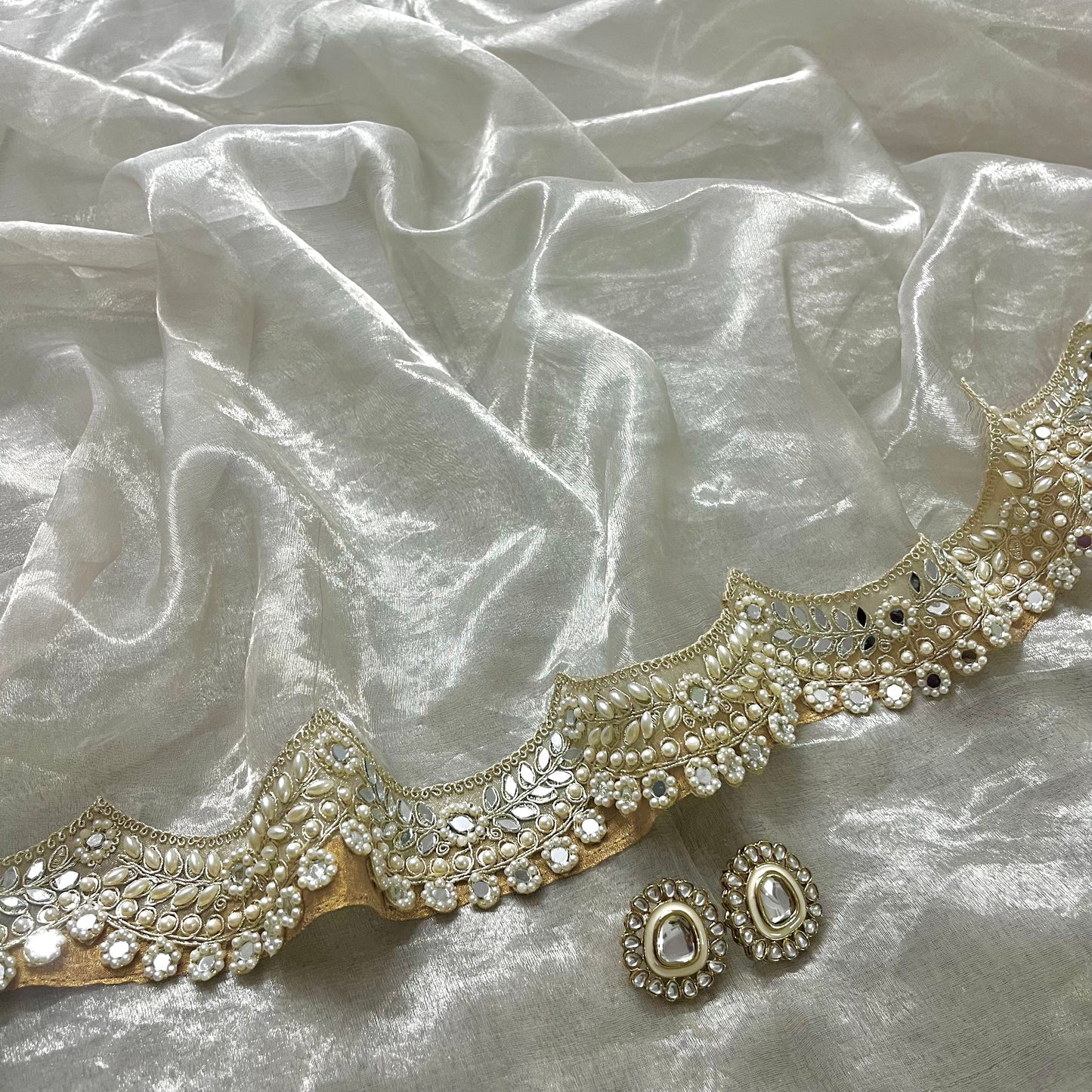 Molten silver chanderi tissue silk saree with pearl and mirror work border