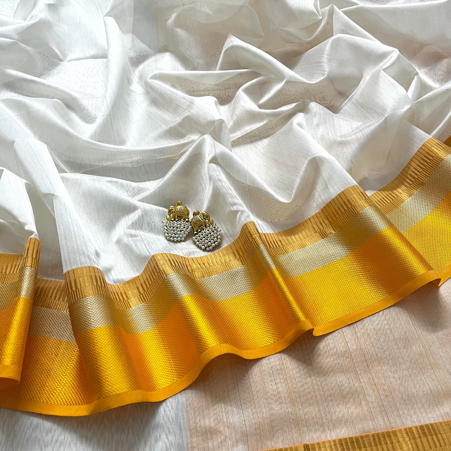 White and yellow maheshwari saree with resham border