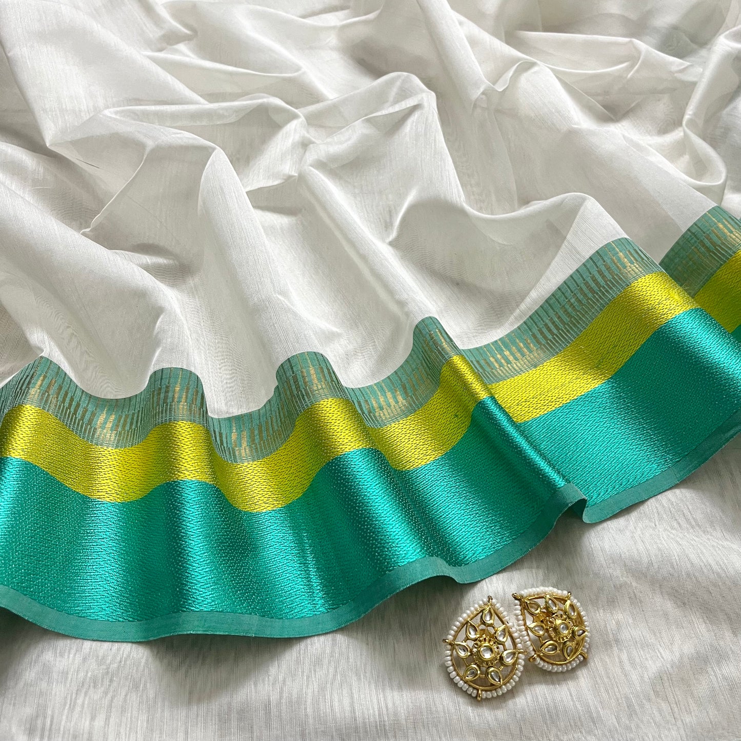White and turquoise maheshwari saree with resham border