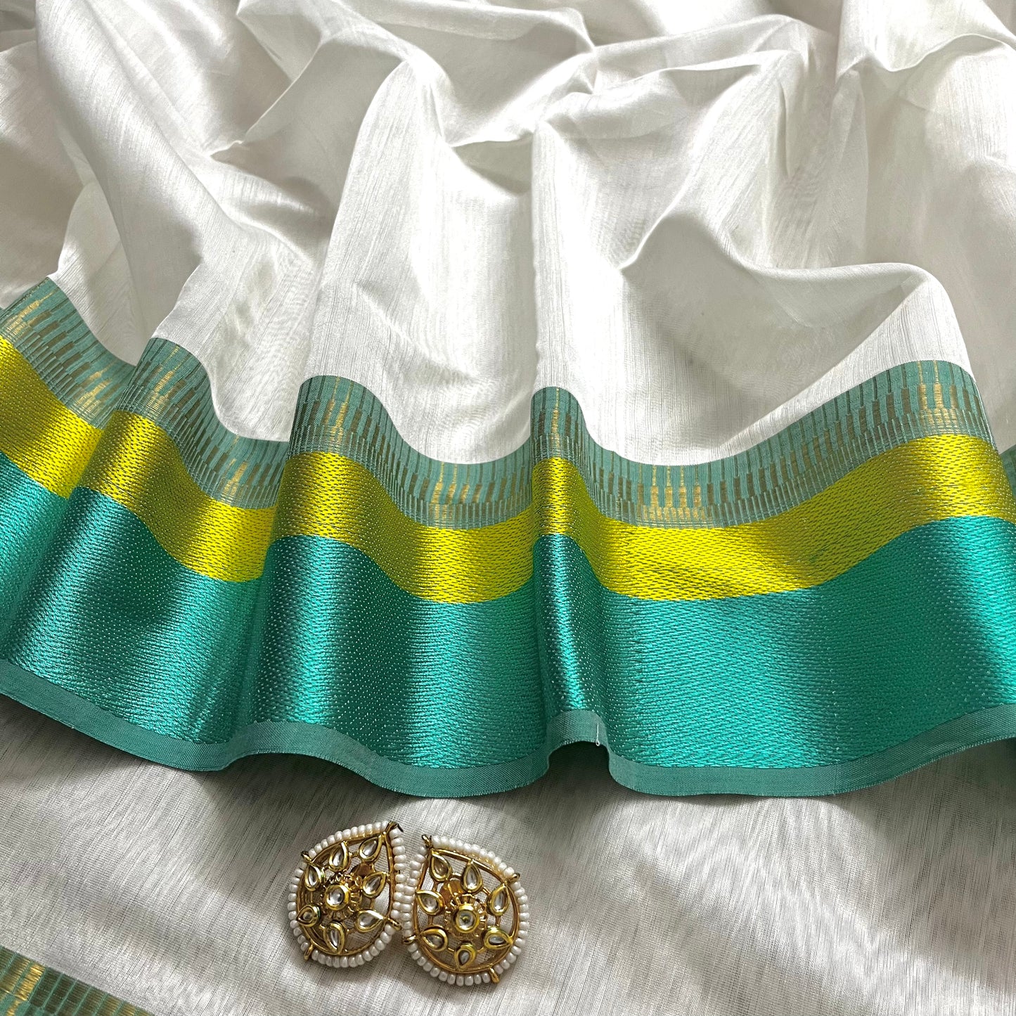 White and turquoise maheshwari saree with resham border