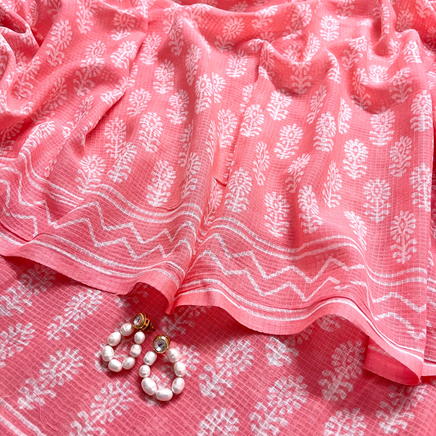 Peachish pink kota checks saree with block print all over