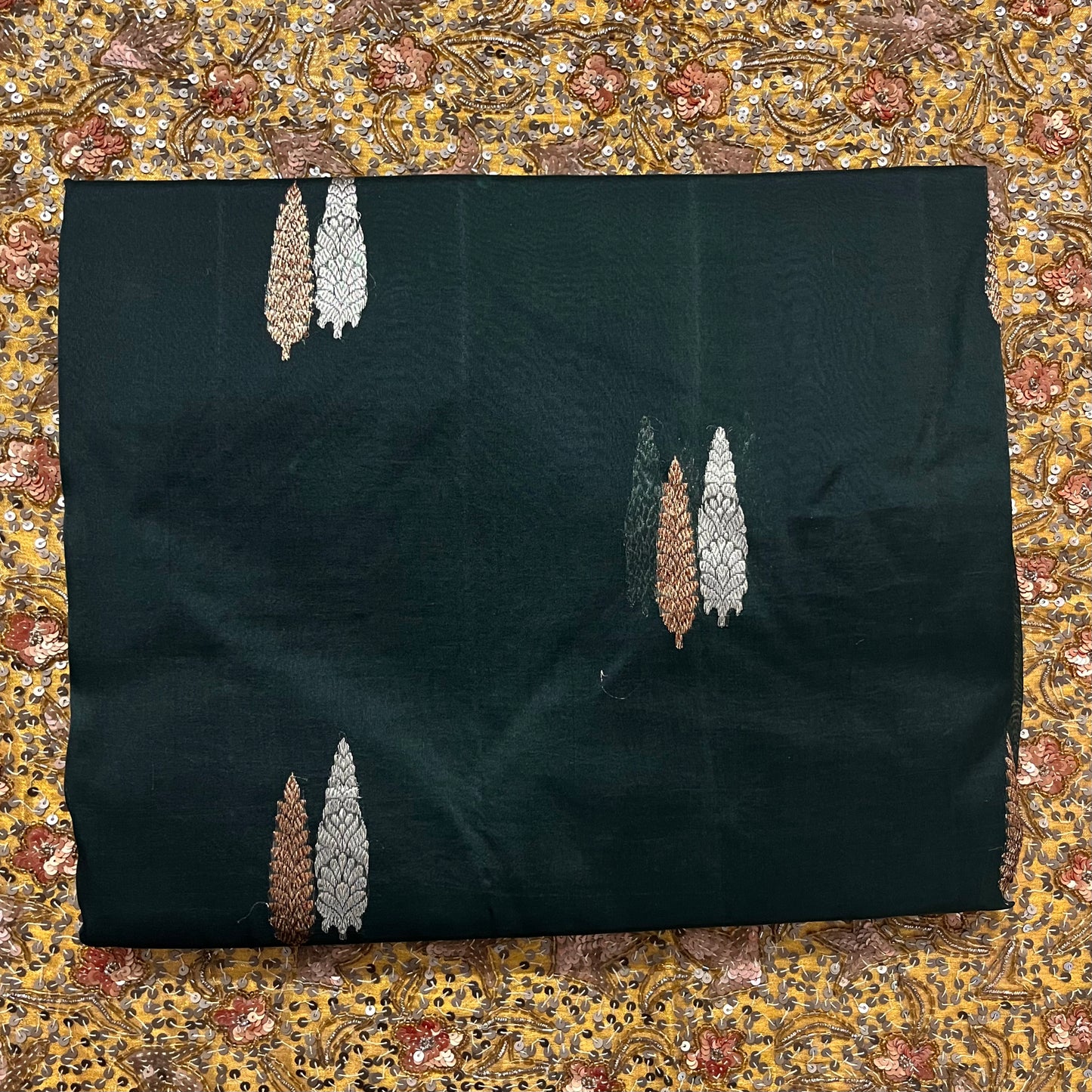 Dark green banarasi organza silk saree with zari motifs all over