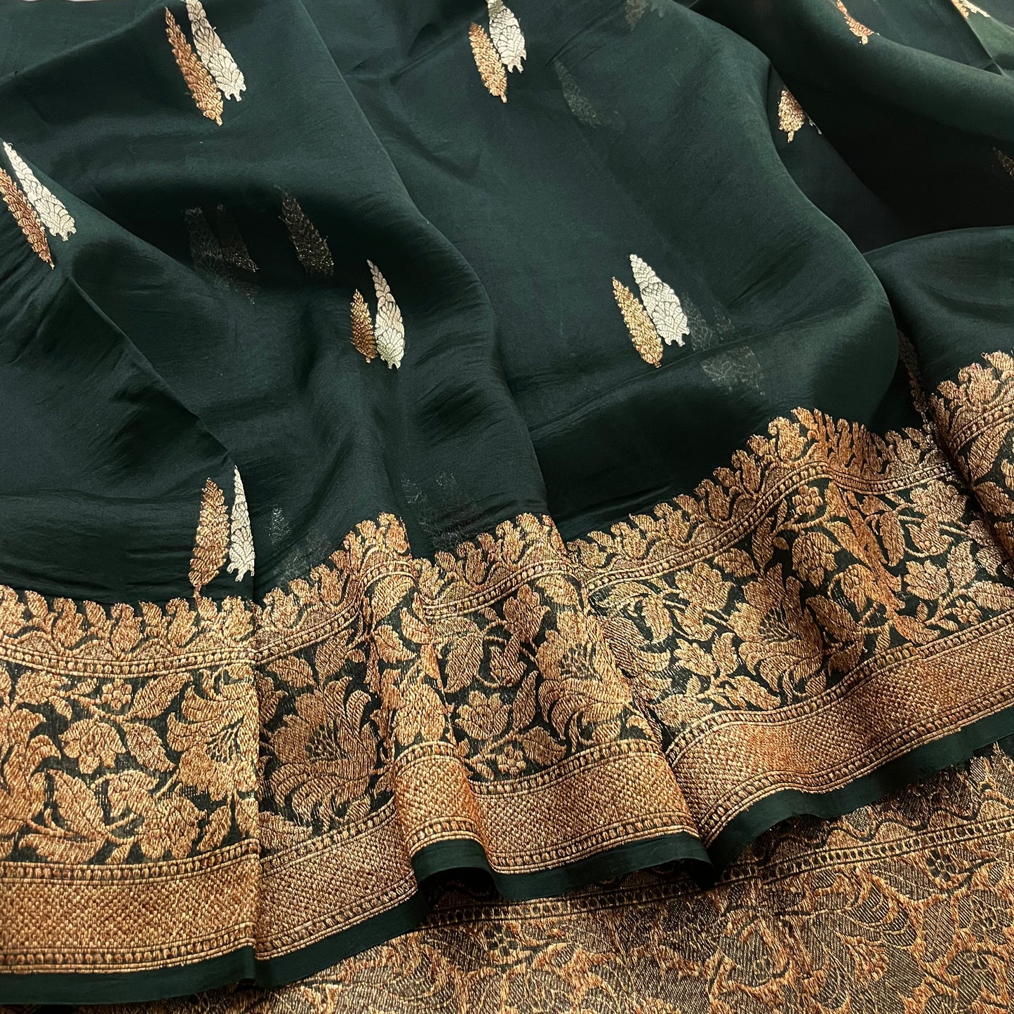 Dark green banarasi organza silk saree with zari motifs all over