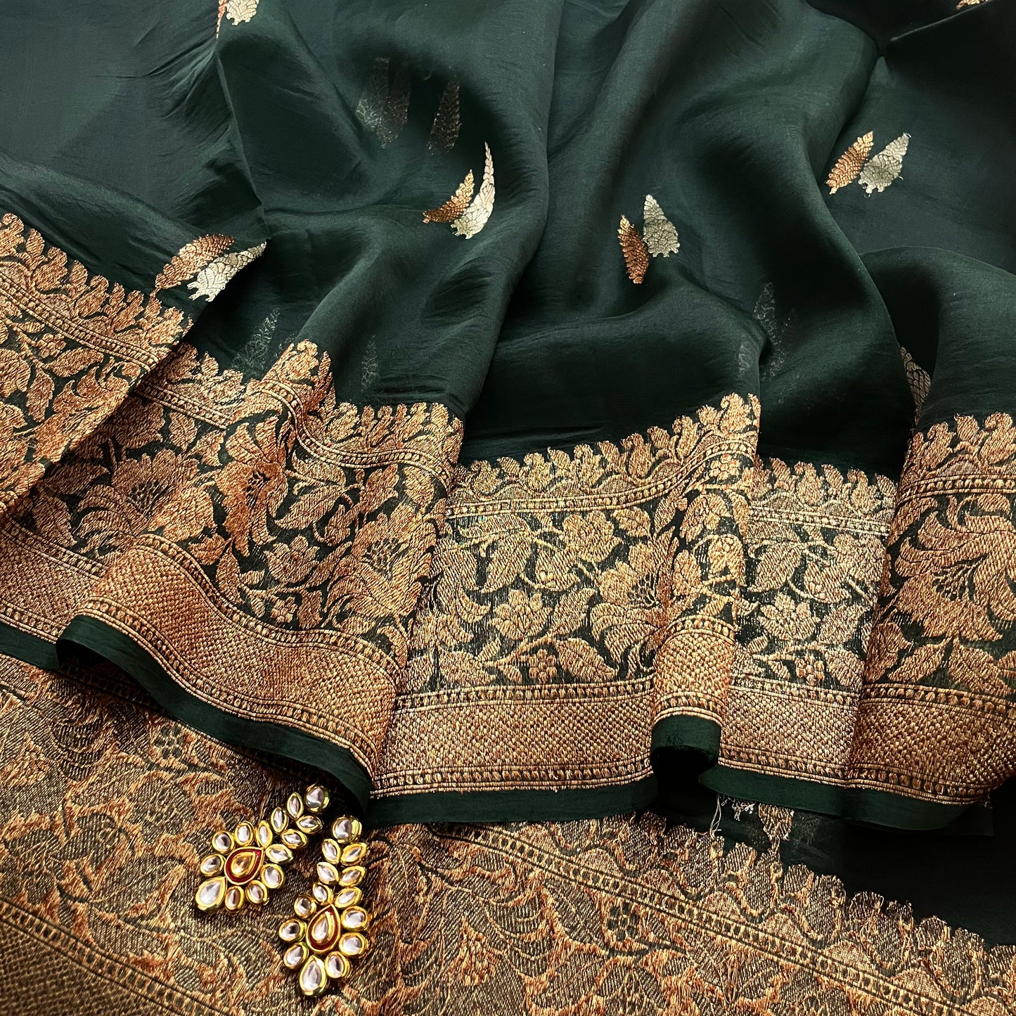 Dark green banarasi organza silk saree with zari motifs all over