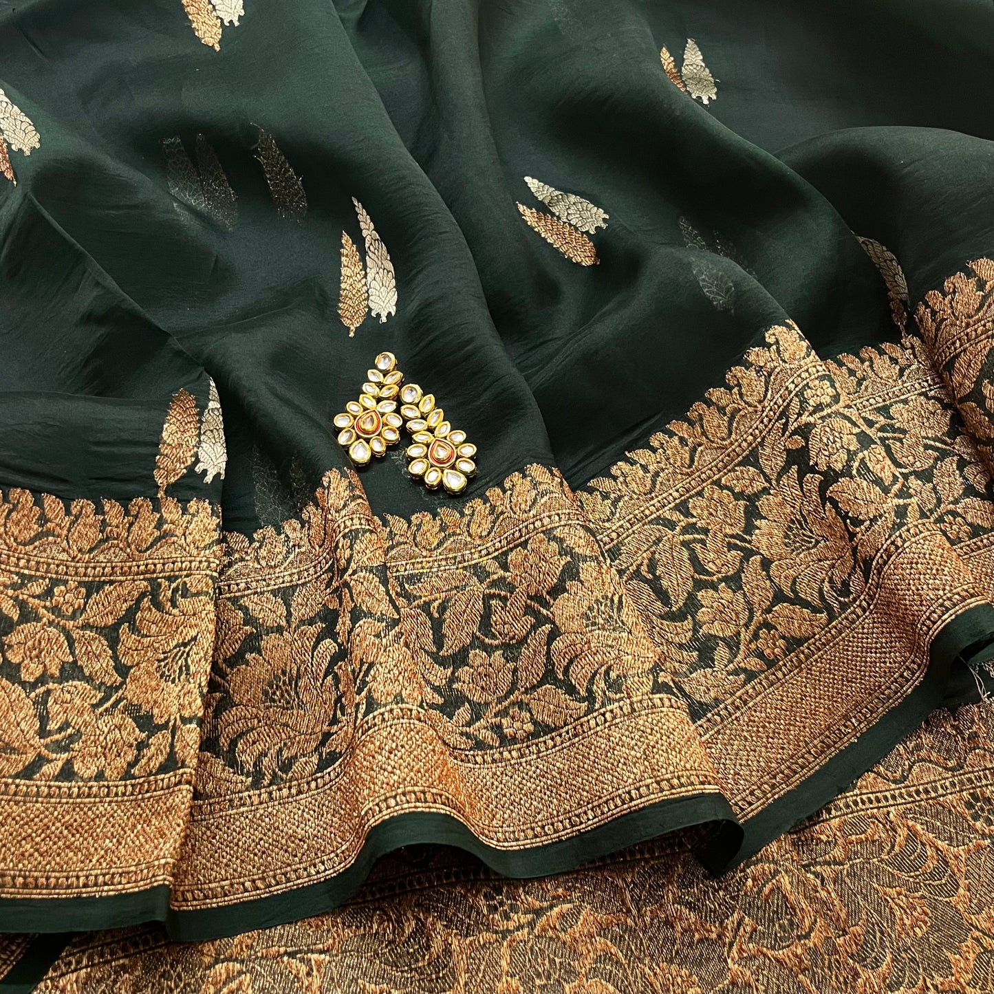 Dark green banarasi organza silk saree with zari motifs all over