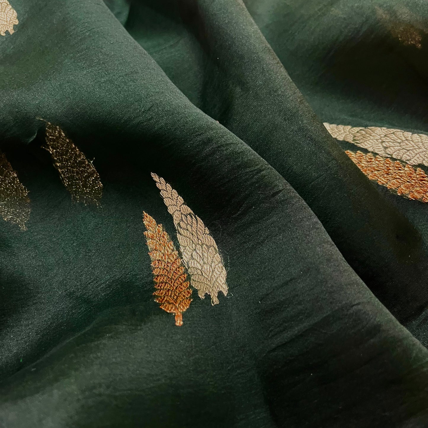 Dark green banarasi organza silk saree with zari motifs all over