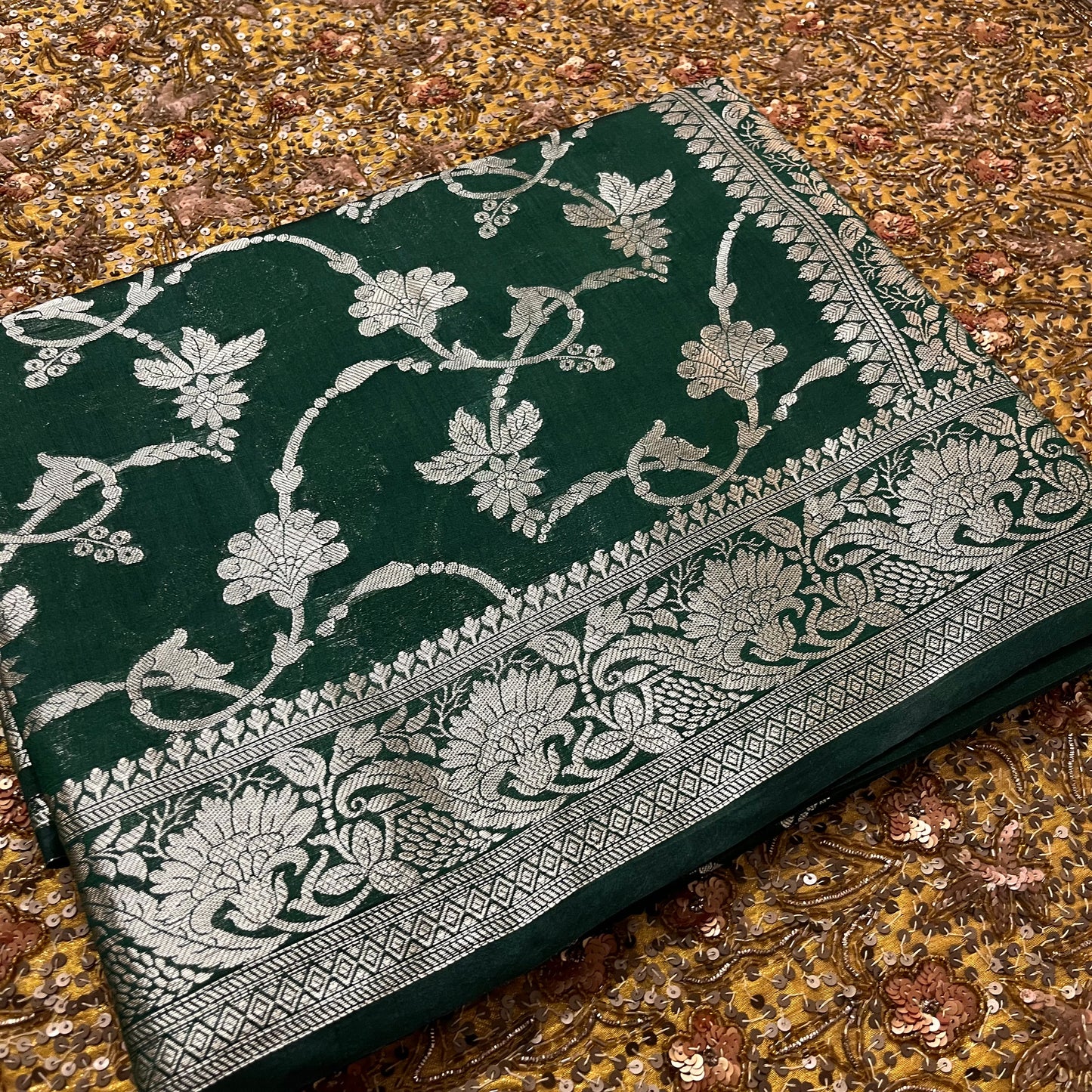 Dark green banarasi silk saree with zari pattern all over