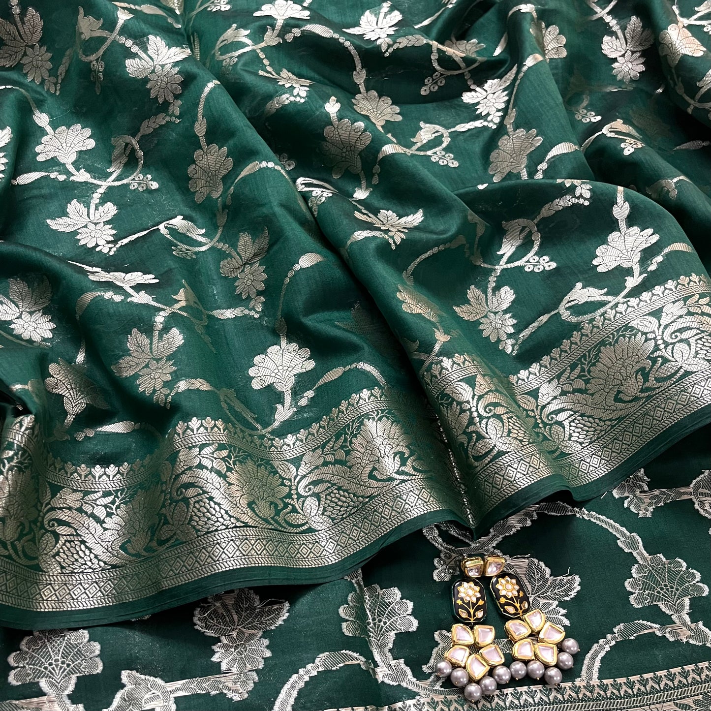 Dark green banarasi silk saree with zari pattern all over