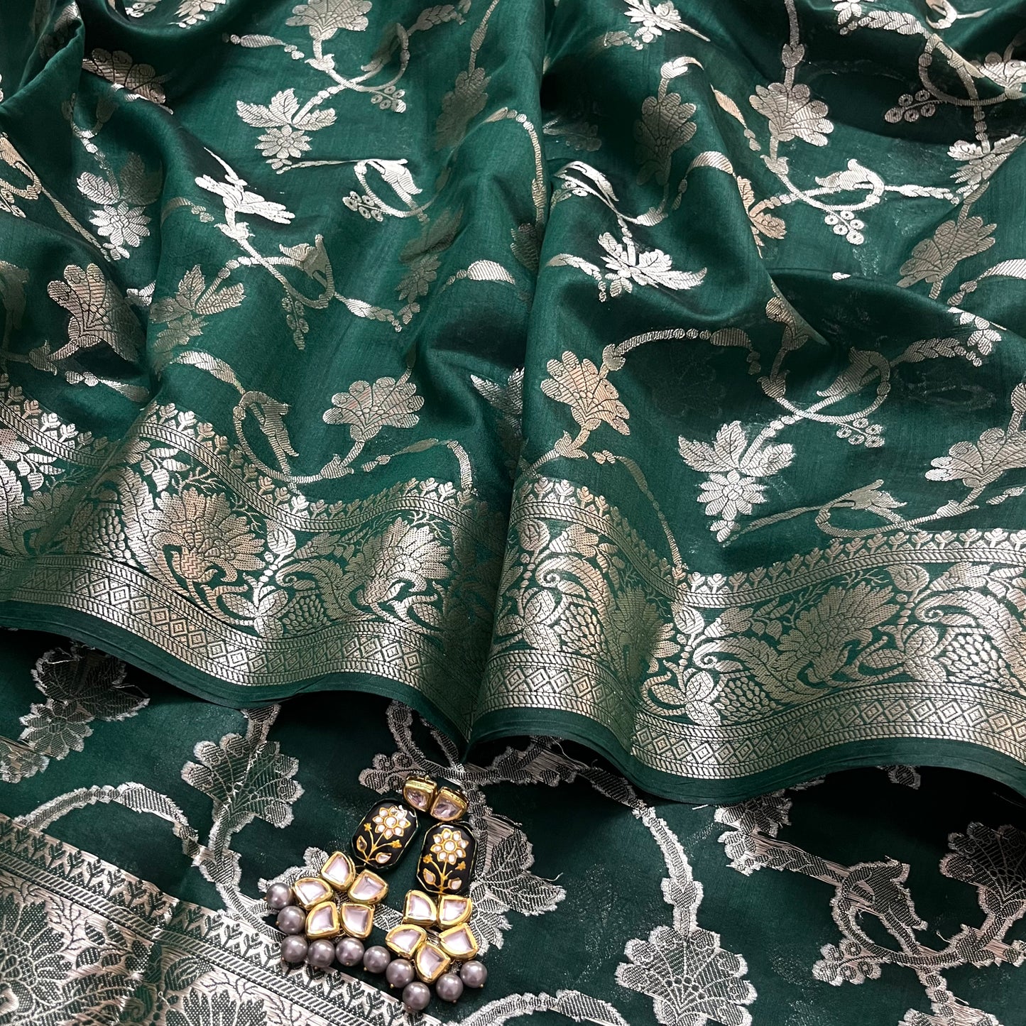 Dark green banarasi silk saree with zari pattern all over