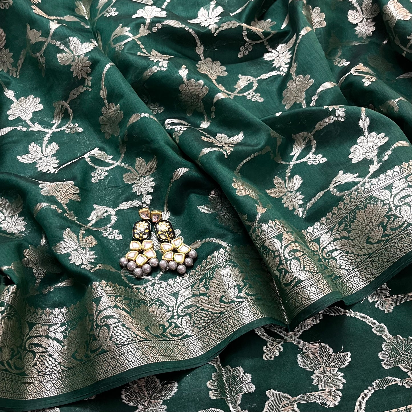 Dark green banarasi silk saree with zari pattern all over