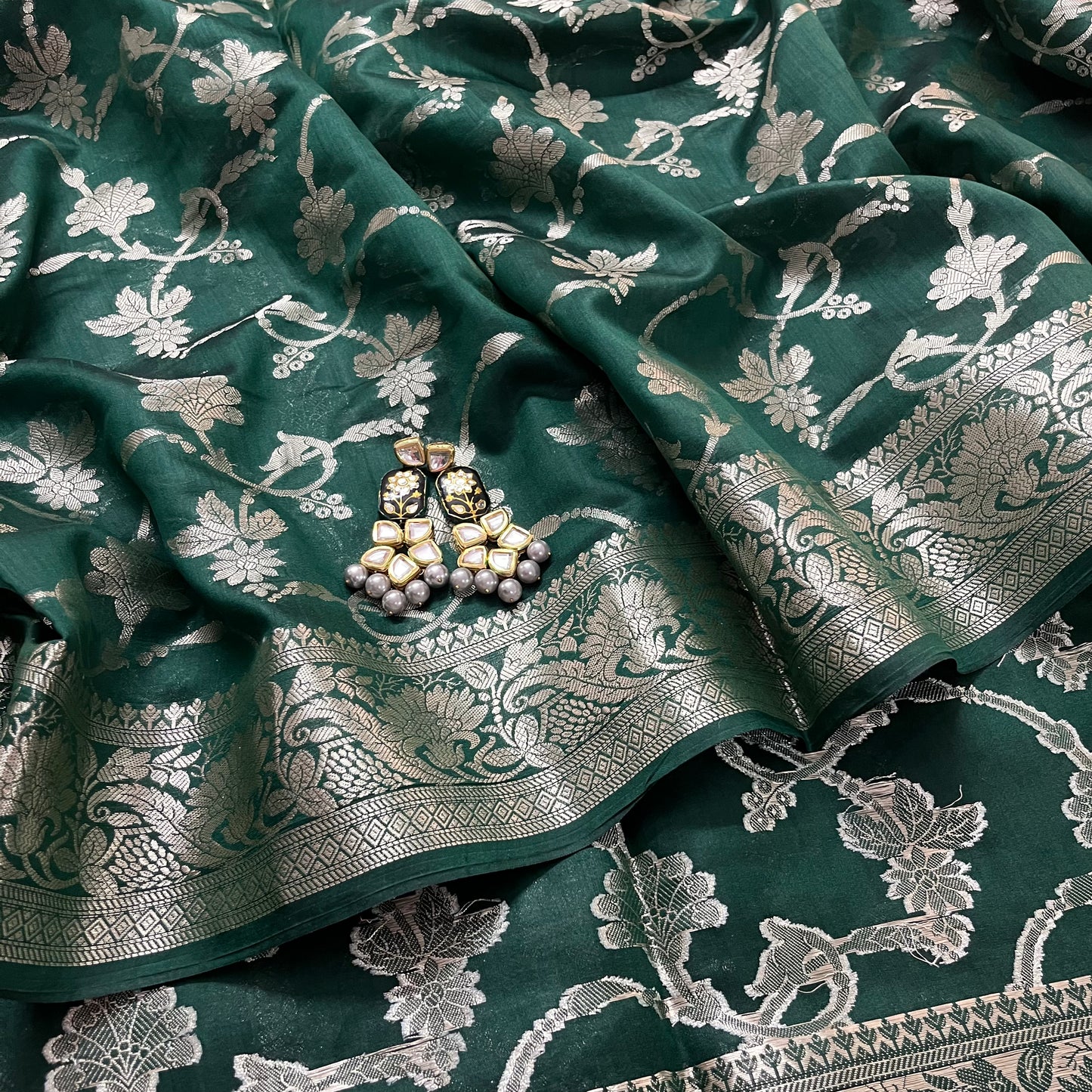 Dark green banarasi silk saree with zari pattern all over