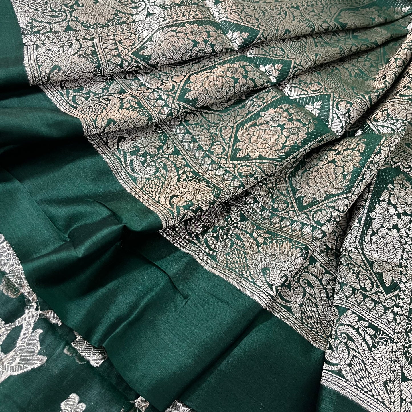 Dark green banarasi silk saree with zari pattern all over