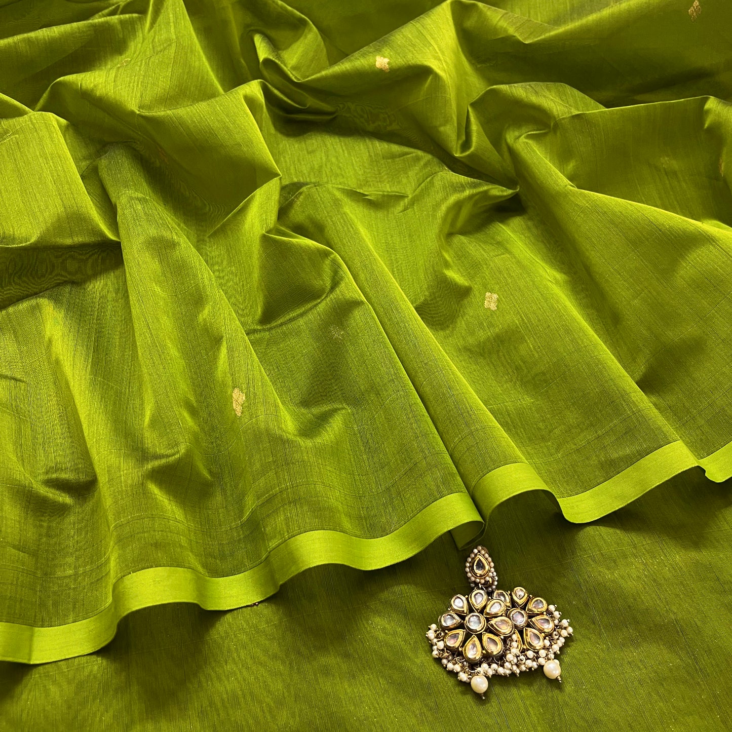Olive green maheshwari saree with zari bootis all over