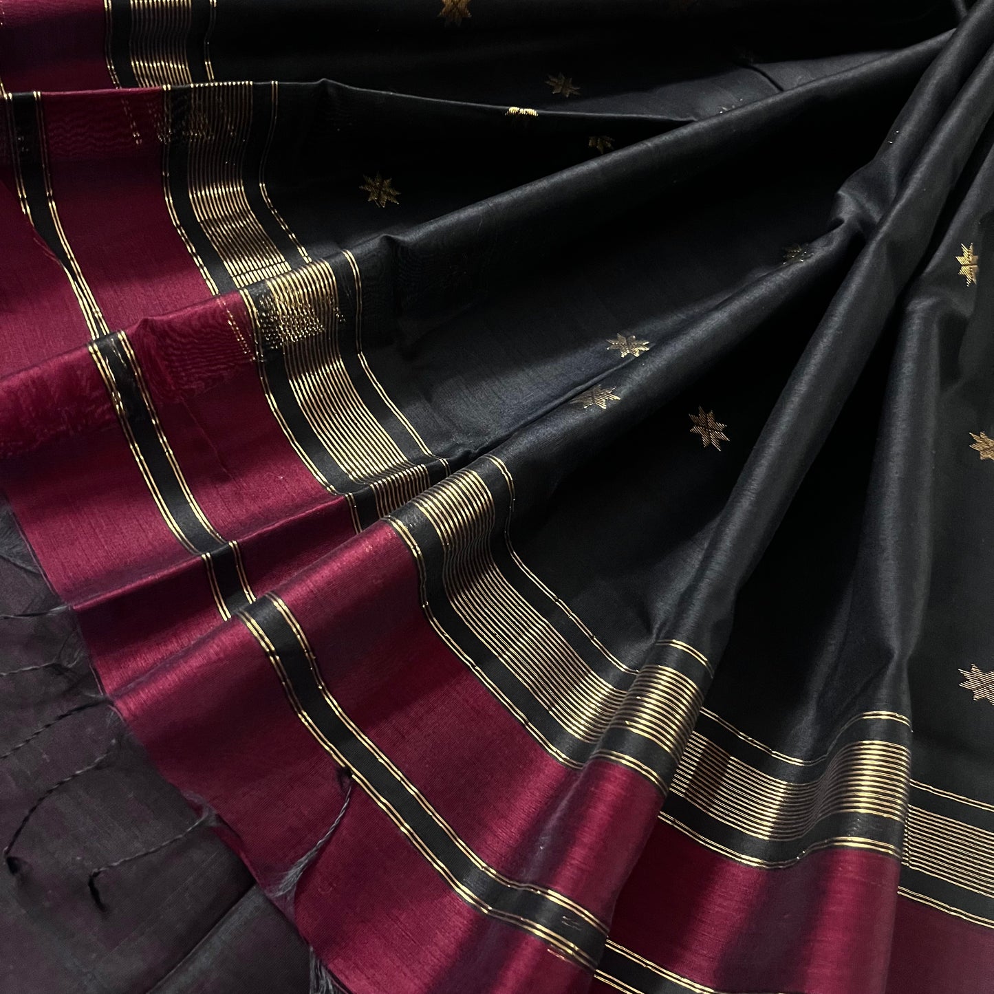 Maroon and black maheshwari saree with flower bootis all over