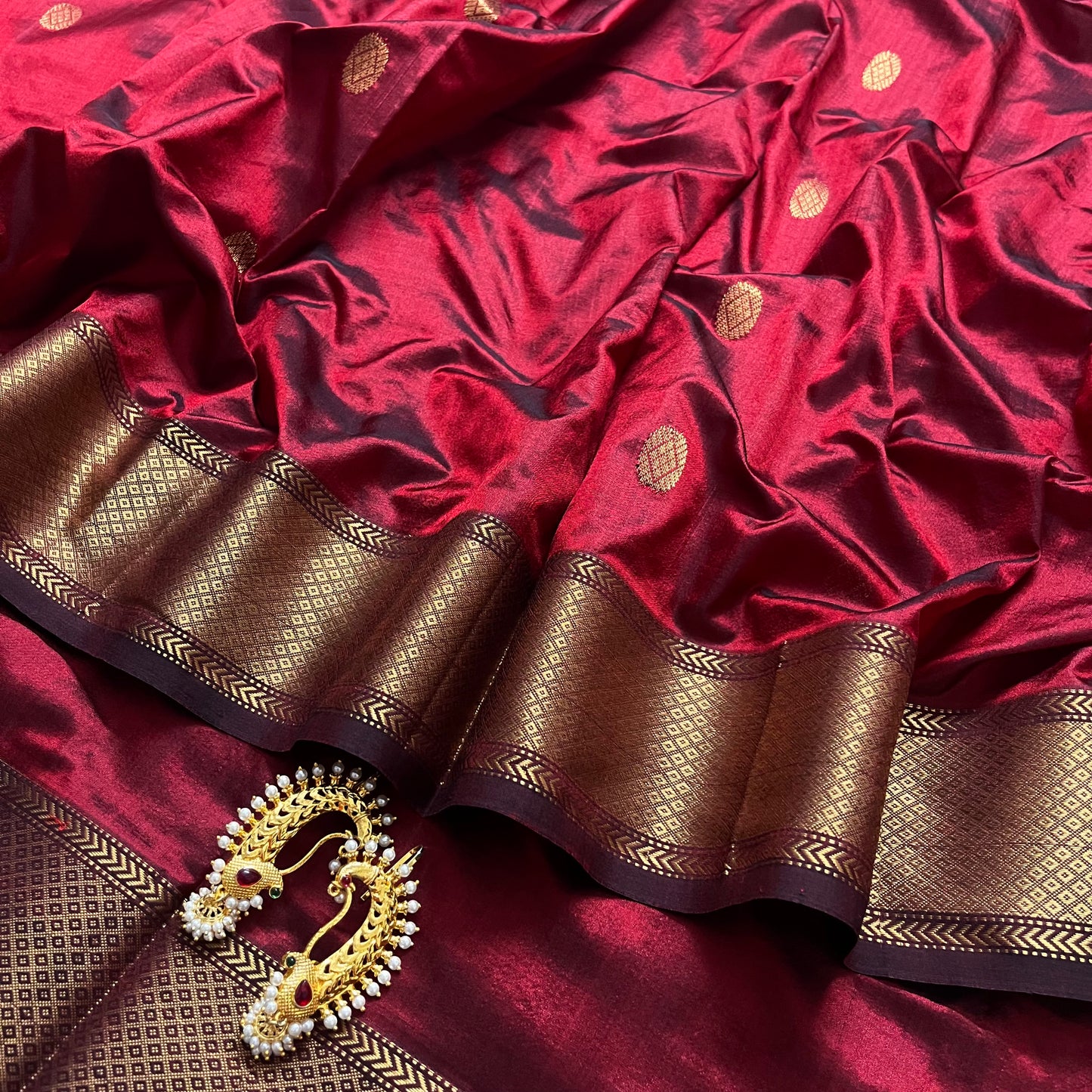 Deep maroon Maheshwari silk saree with zari bootis all over