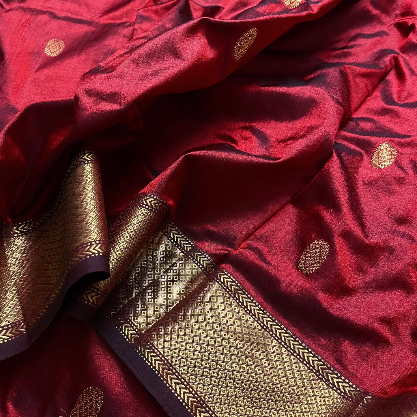 Deep maroon Maheshwari silk saree with zari bootis all over