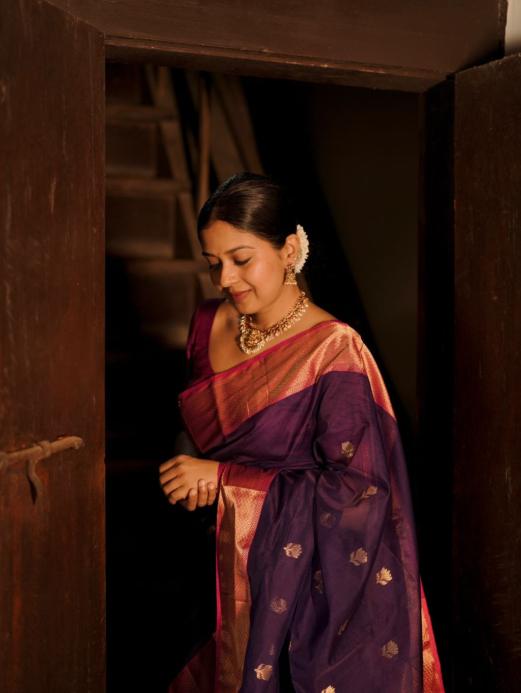 Dark purple and pink maheshwari saree with flower motifs all over