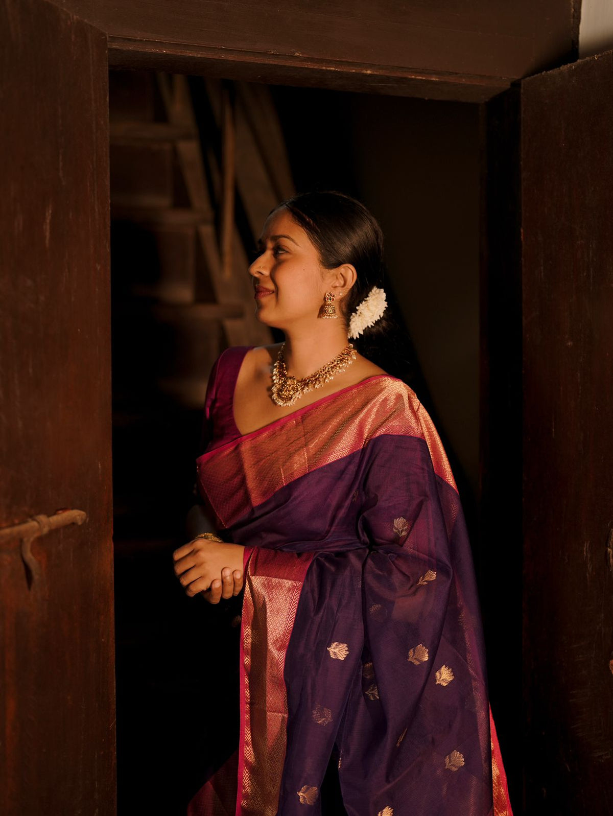 Dark purple and pink maheshwari saree with flower motifs all over