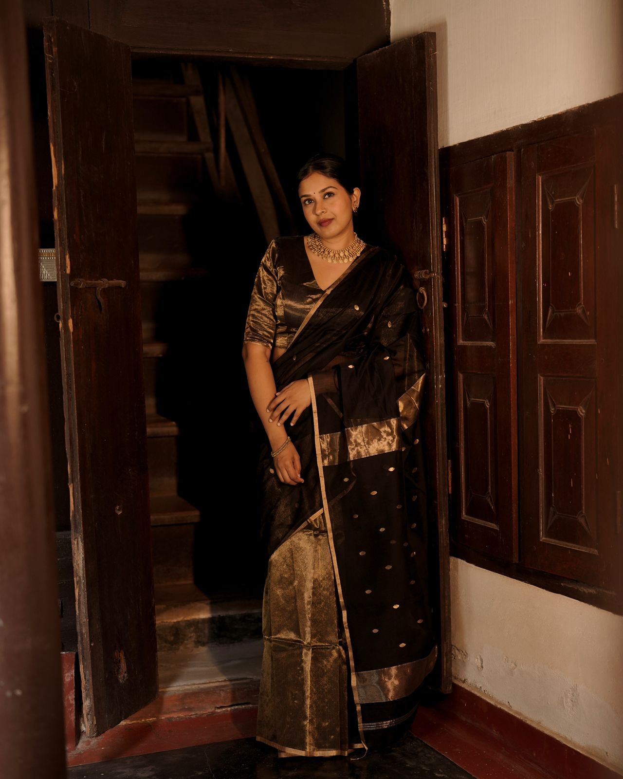 Black and gold maheshwari saree with zari bootis and zari lines all over