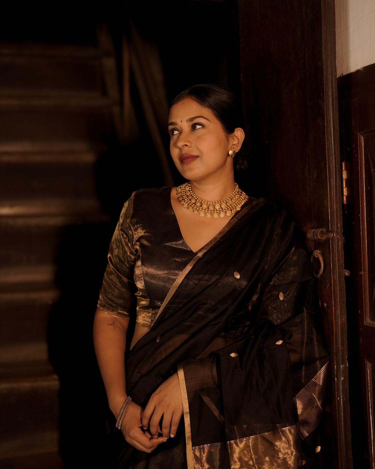 Black and gold maheshwari saree with zari bootis and zari lines all over