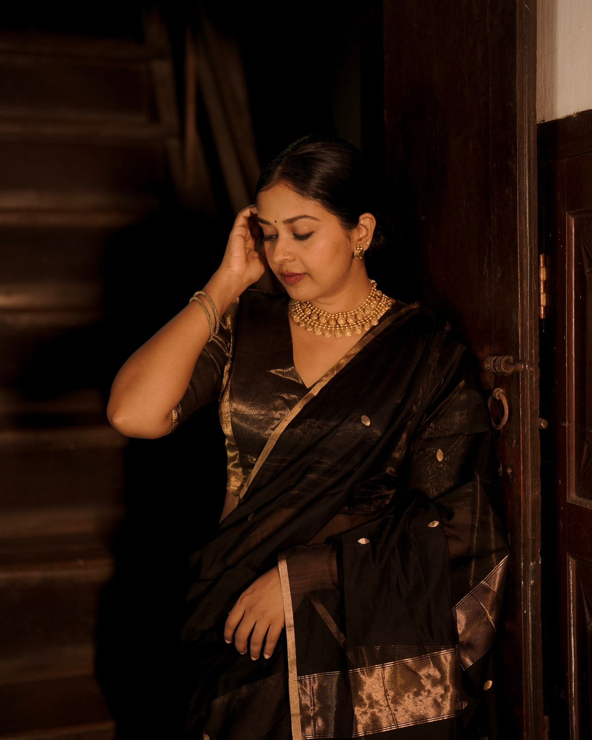 Black and gold maheshwari saree with zari bootis and zari lines all over