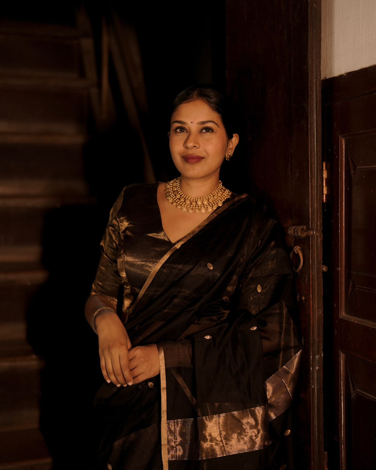 Black and gold maheshwari saree with zari bootis and zari lines all over