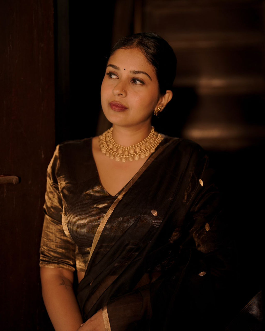 Black and gold maheshwari saree with zari bootis and zari lines all over