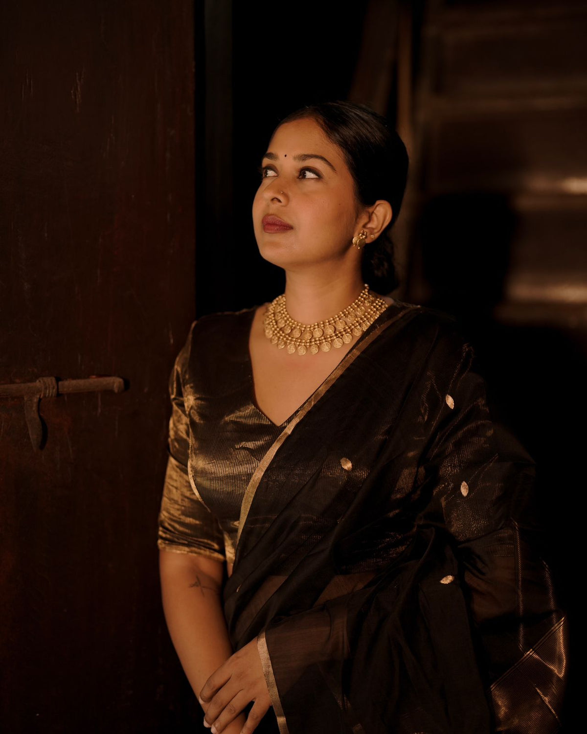 Black and gold maheshwari saree with zari bootis and zari lines all over