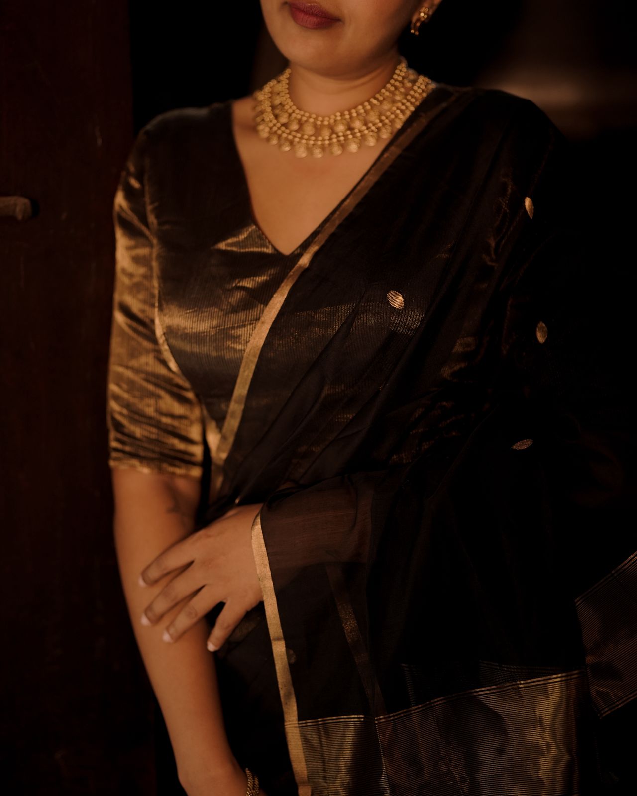 Black and gold maheshwari saree with zari bootis and zari lines all over
