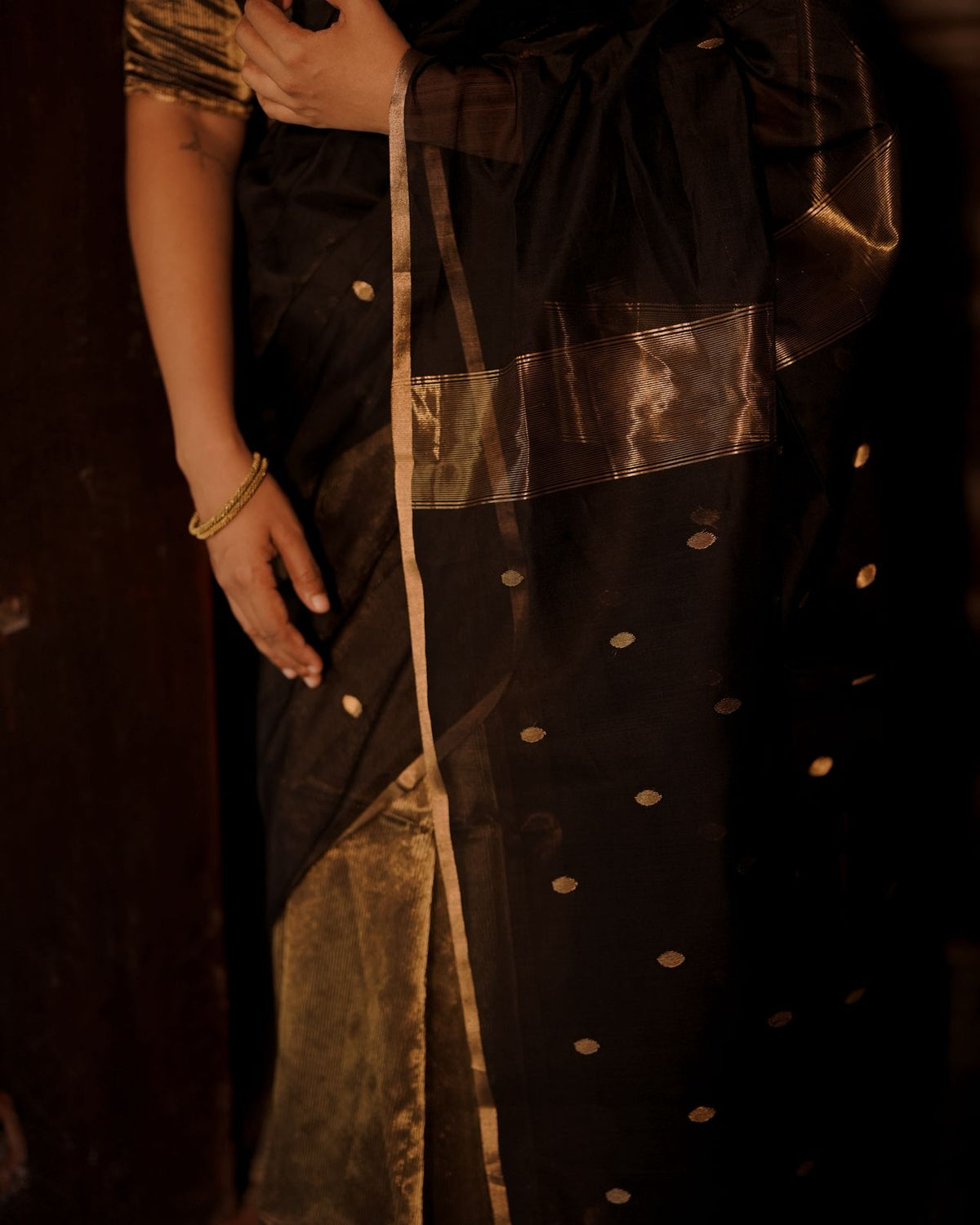 Black and gold maheshwari saree with zari bootis and zari lines all over