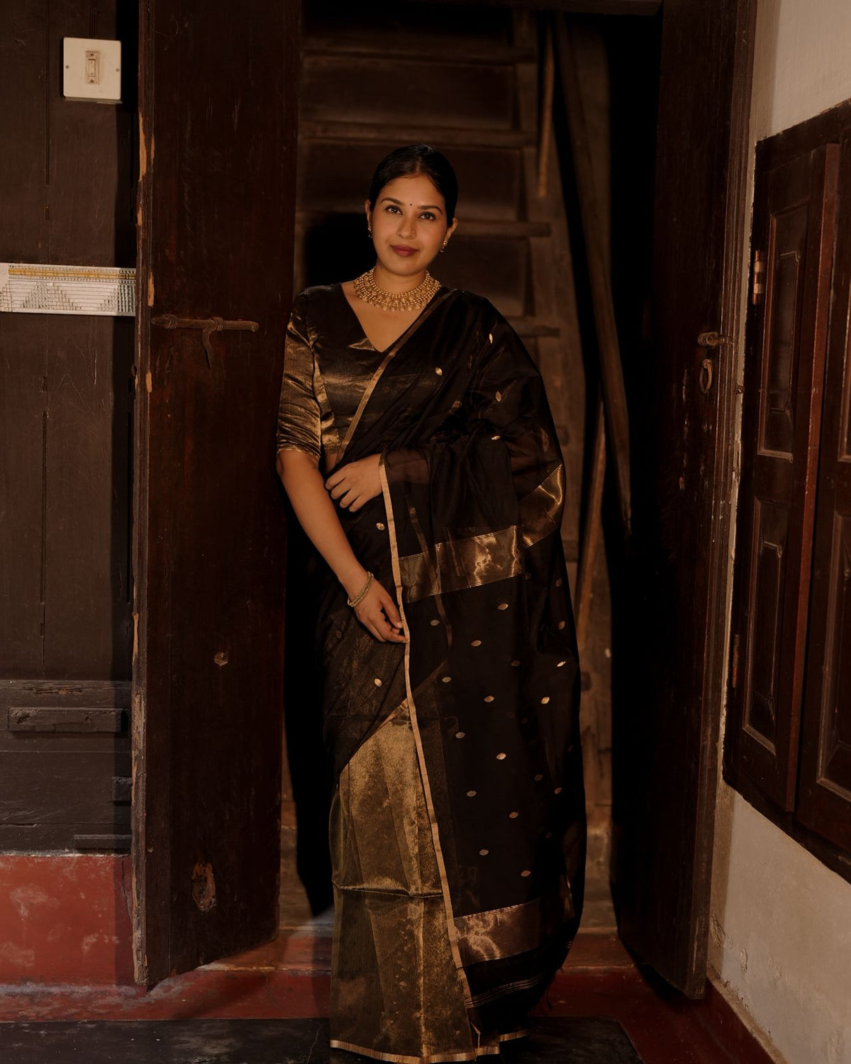 Black and gold maheshwari saree with zari bootis and zari lines all over