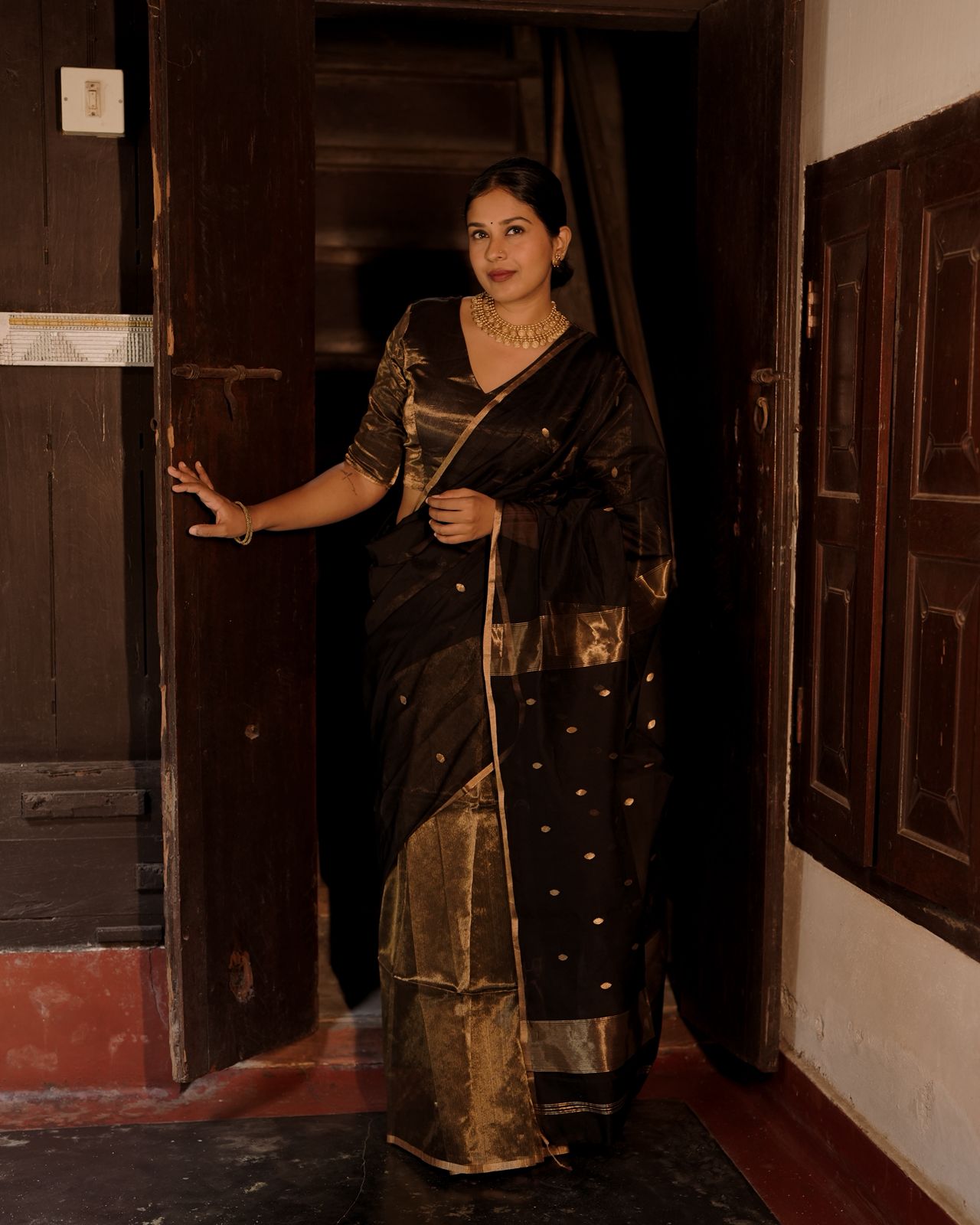 Black and gold maheshwari saree with zari bootis and zari lines all over