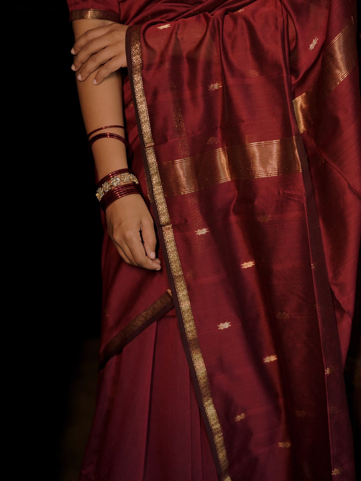 Deep maroon Maheshwari saree with flower bootis all over
