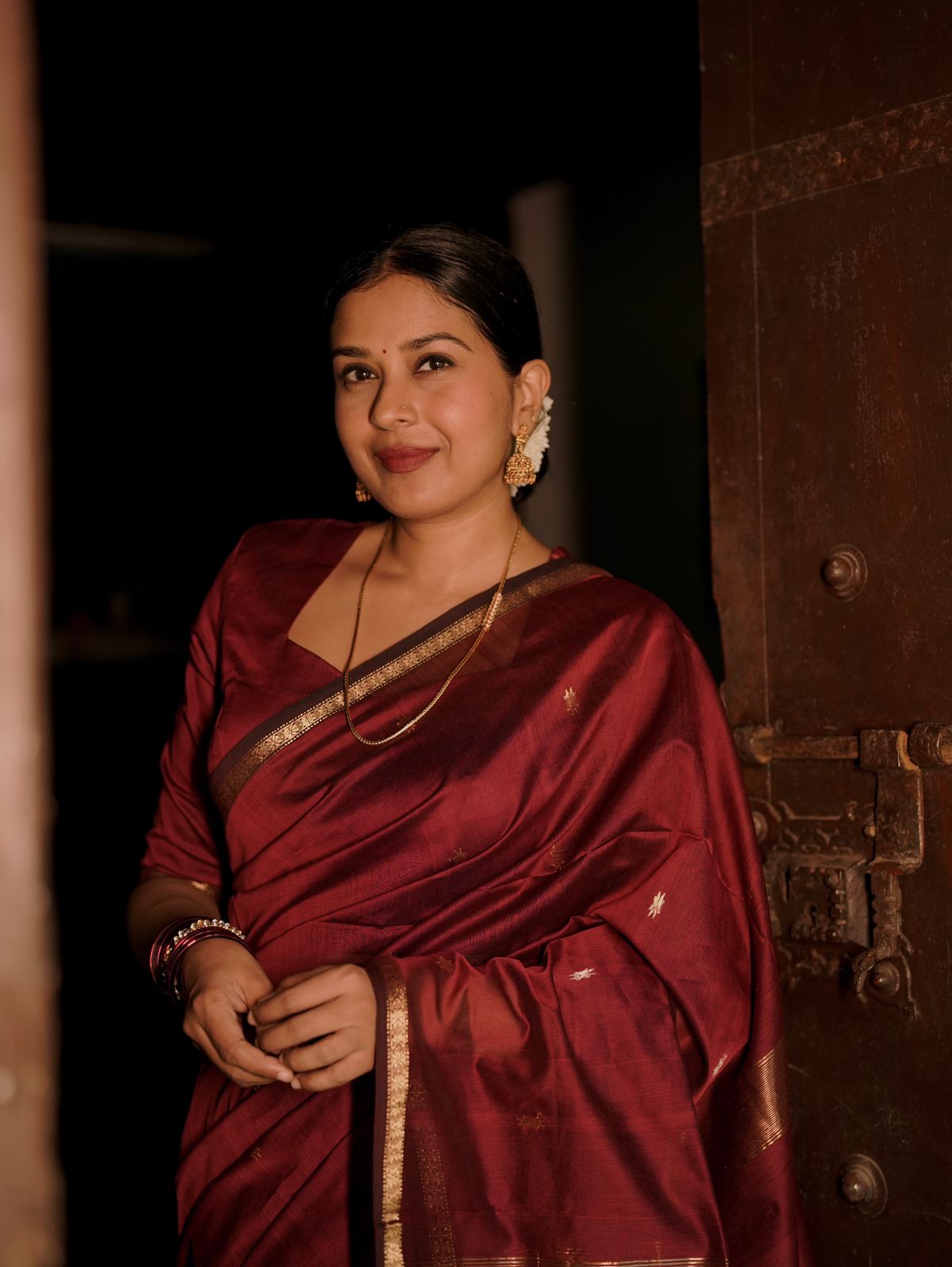 Deep maroon Maheshwari saree with flower bootis all over