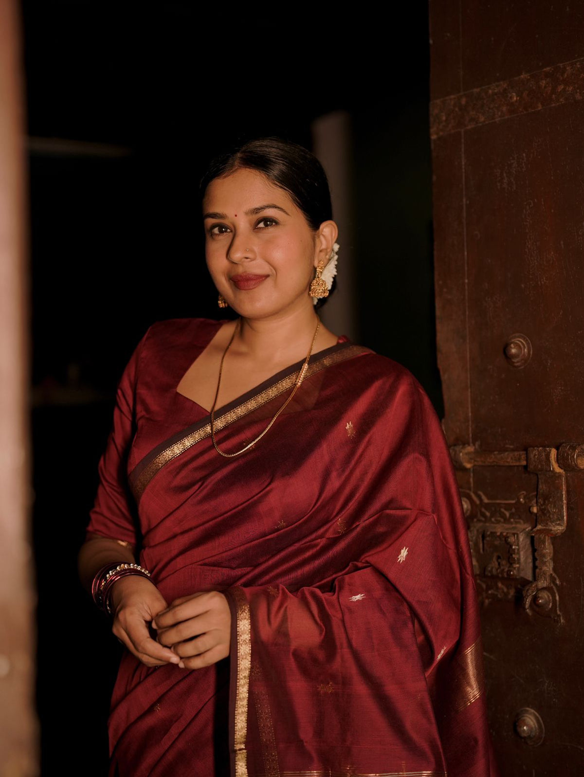 Deep maroon Maheshwari saree with flower bootis all over