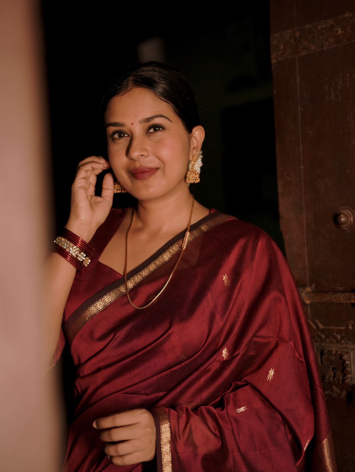 Deep maroon Maheshwari saree with flower bootis all over