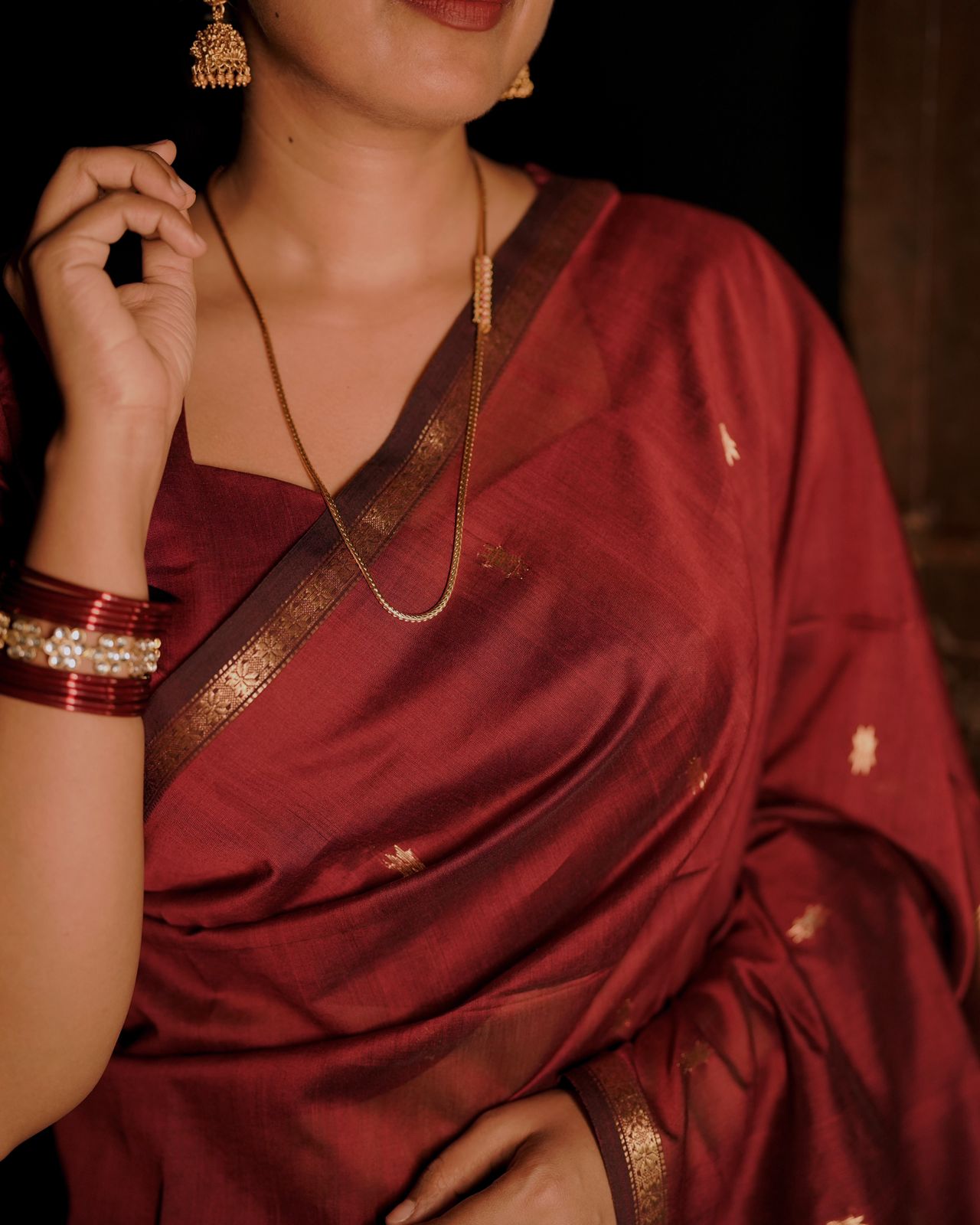 Deep maroon Maheshwari saree with flower bootis all over