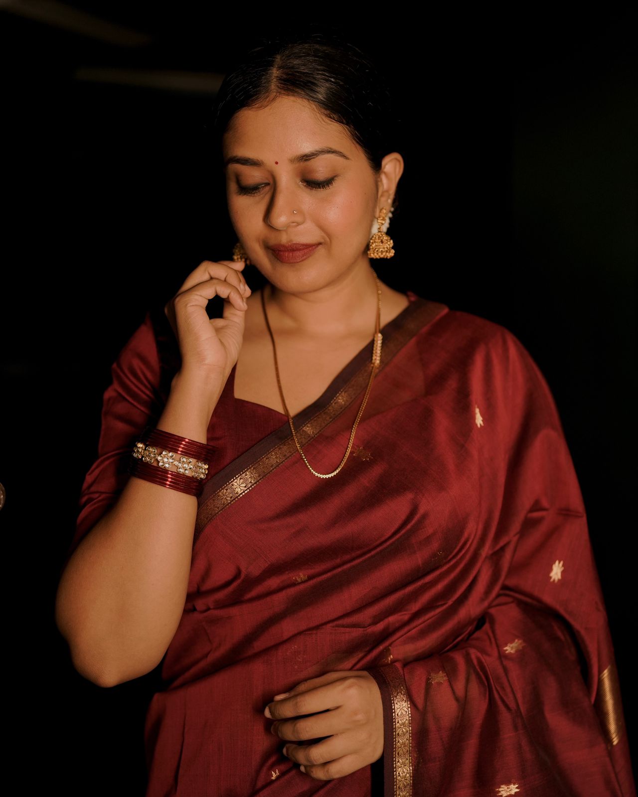 Deep maroon Maheshwari saree with flower bootis all over