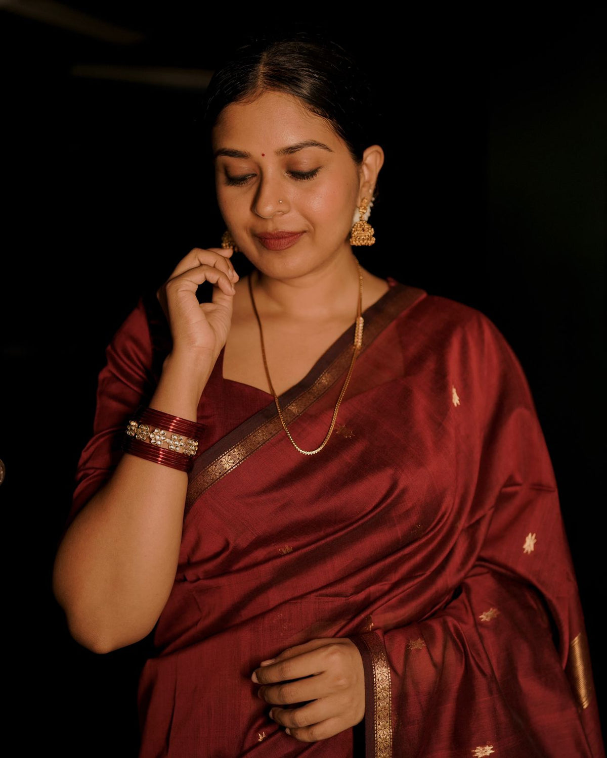 Deep maroon Maheshwari saree with flower bootis all over