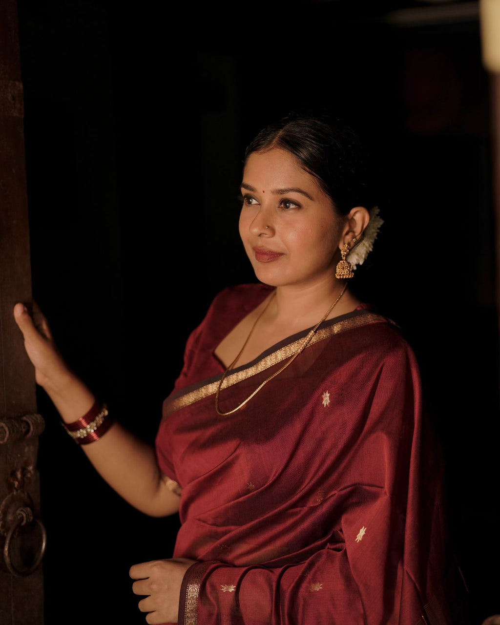 Deep maroon Maheshwari saree with flower bootis all over
