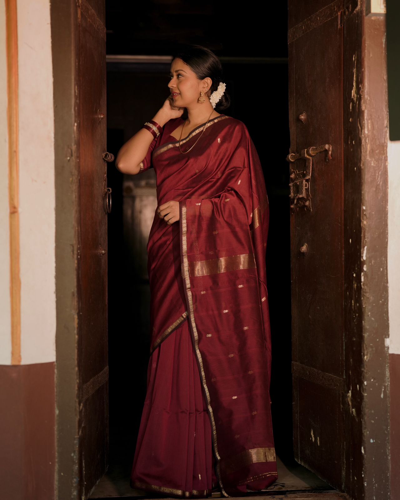 Deep maroon Maheshwari saree with flower bootis all over