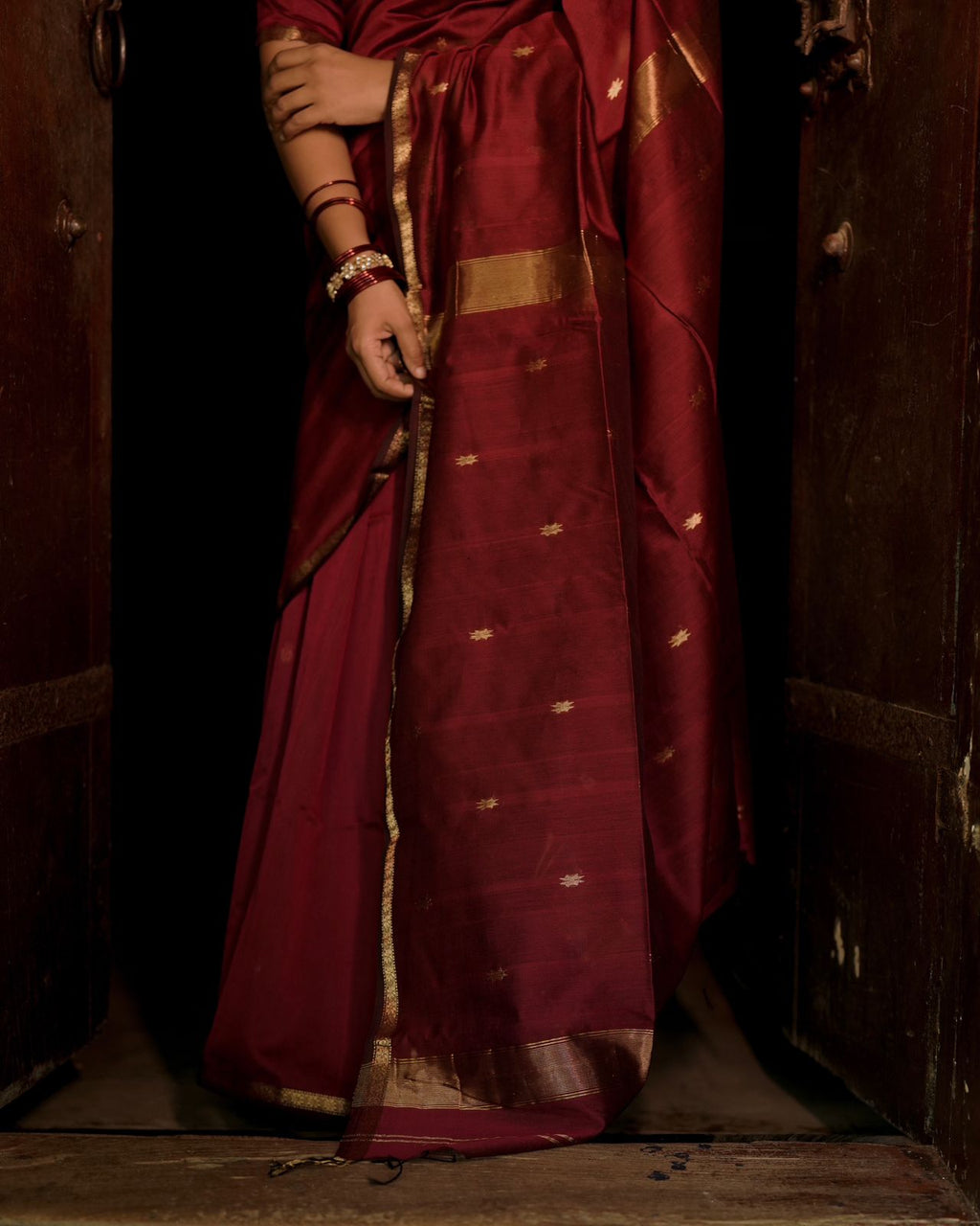 Deep maroon Maheshwari saree with flower bootis all over