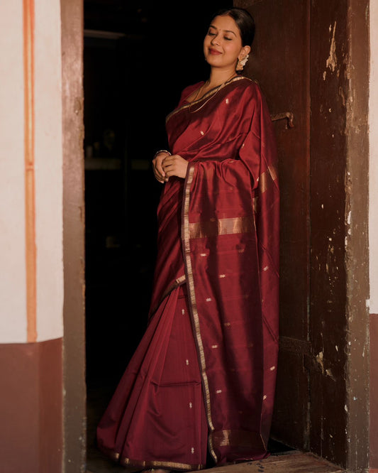 Deep maroon Maheshwari saree with flower bootis all over